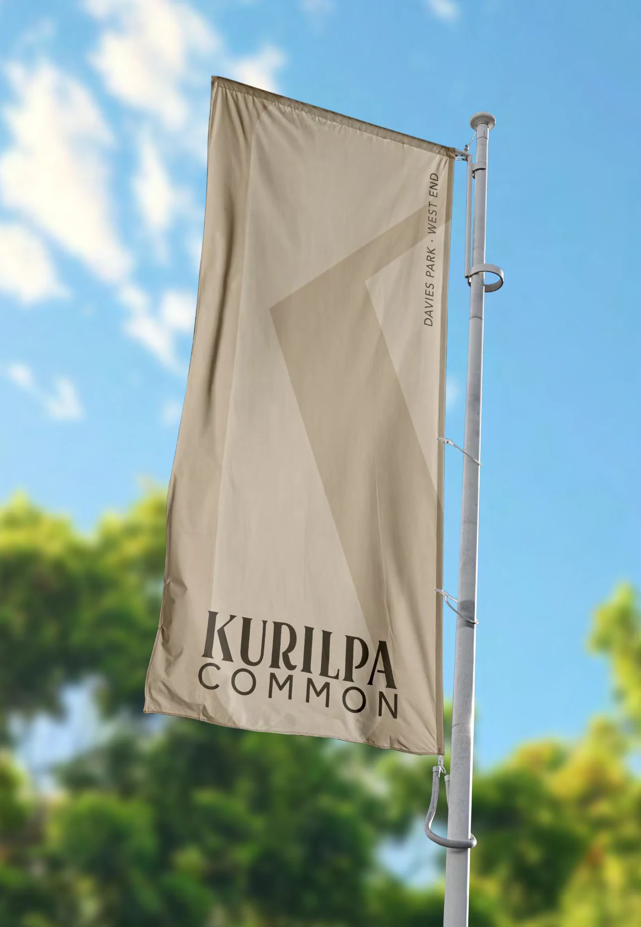 Kurilpa Common wordmark on a sand-coloured flag